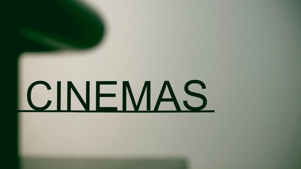 Minimalist cinema sign on pastel background, conveying a contemporary urban vibe.